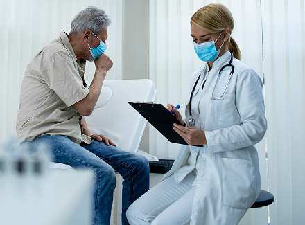 old-man-coughing-while-doctor-writing-down-symptoms-hospital-office-corona-virus-pandemic 1